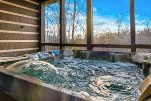 A hot tub with a view of trees through large windows. - Luxury, Chalet with Private Suite, Secluded, and HotTub (Cosby)