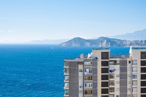 A high-rise building with balconies overlooking a coastal cityscape and the sea. - Tropic Mar Apartment 15A Levante Beach (Benidorm)