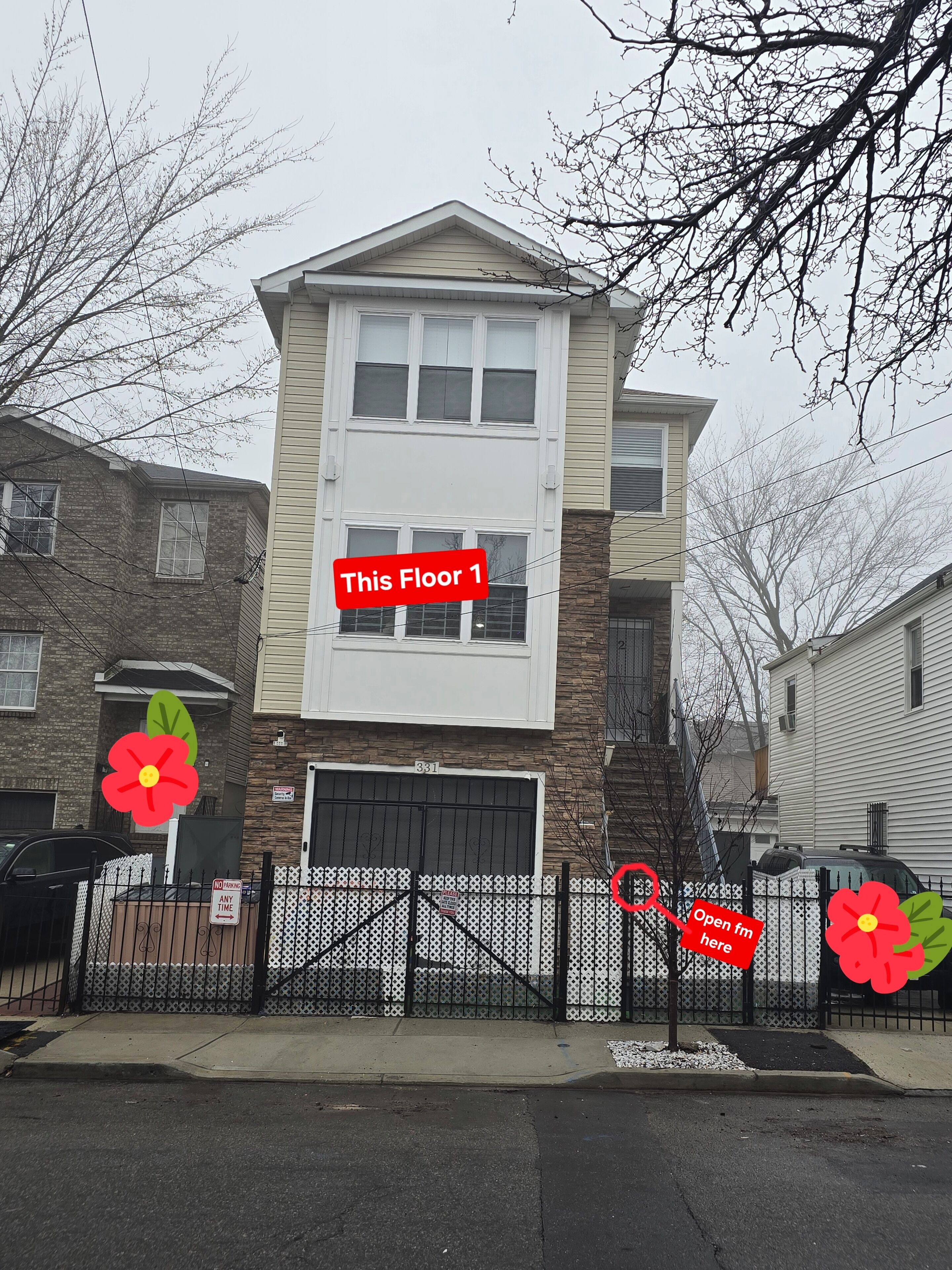 A two-story residential building with a garage, a gated driveway, and a 'No Parking Any Time' sign.