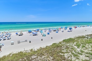 A beach with tents, umbrellas, and beach chairs. - Tidewater 201•Remodeled•Beachfront•Pools&Hot Tubs •Beach Gear•Fitness Center (Panama City Beach)