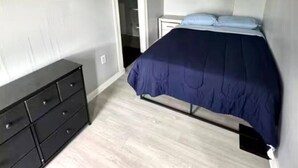 A bedroom with a bed, a dresser, and a walk-in closet. - (H2) 2 Bdrm Apt Inner Harbor (Syracuse)