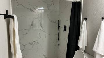 Shower, hair dryer, towels, toilet paper