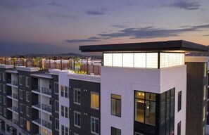 A multi-story building with a flat roof, large windows, and a flat facade.