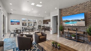 A spacious living area with a large TV, comfortable seating, a kitchen, and a dining area. - Ocotillo Springs 53, Private Pool, Spa, Resort Amenities (Santa Clara)