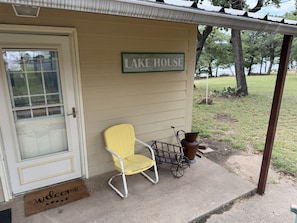 A small building with a sign reading 'LAKE HOUSE' and a yellow chair outside. - Cowboy On The Water at Lake Palo Pinto. Private Dock, New Remodel. Howdy Y'all. (Gordon)