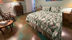A bedroom with a bed, a chair, a dresser, and a painting on the wall. - Cowboy On The Water at Lake Palo Pinto. Private Dock, New Remodel. Howdy Y'all. (Gordon)
