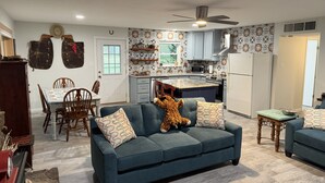 A cozy living room with a sofa, a coffee table, and a teddy bear. - Cowboy On The Water at Lake Palo Pinto. Private Dock, New Remodel. Howdy Y'all. (Gordon)
