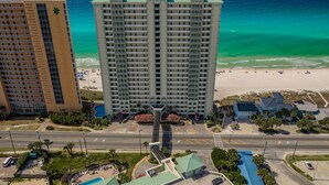A high-rise hotel with a pool, beach view, and a parking lot. - 5 Star Stays • Stocked Luxury Retreat • 2 Kg Suites (Panama City Beach)