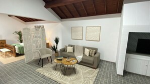 A living room with a sofa, armchair, coffee table, and decorative wall art.