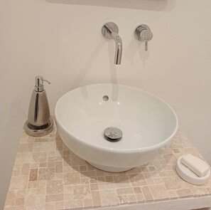 A bathroom with a white sink, a soap dispenser, and a faucet. - Small village farmhouse near Avignon with pine forest view. (Barbentane, Avignon)