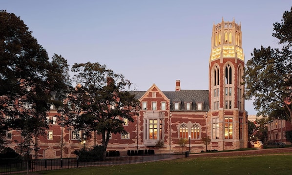 A large brick building with a prominent tower and multiple windows. - Rooftop retreat with game room and 4 ensuite bedrooms near Centennial Park (Nashville)