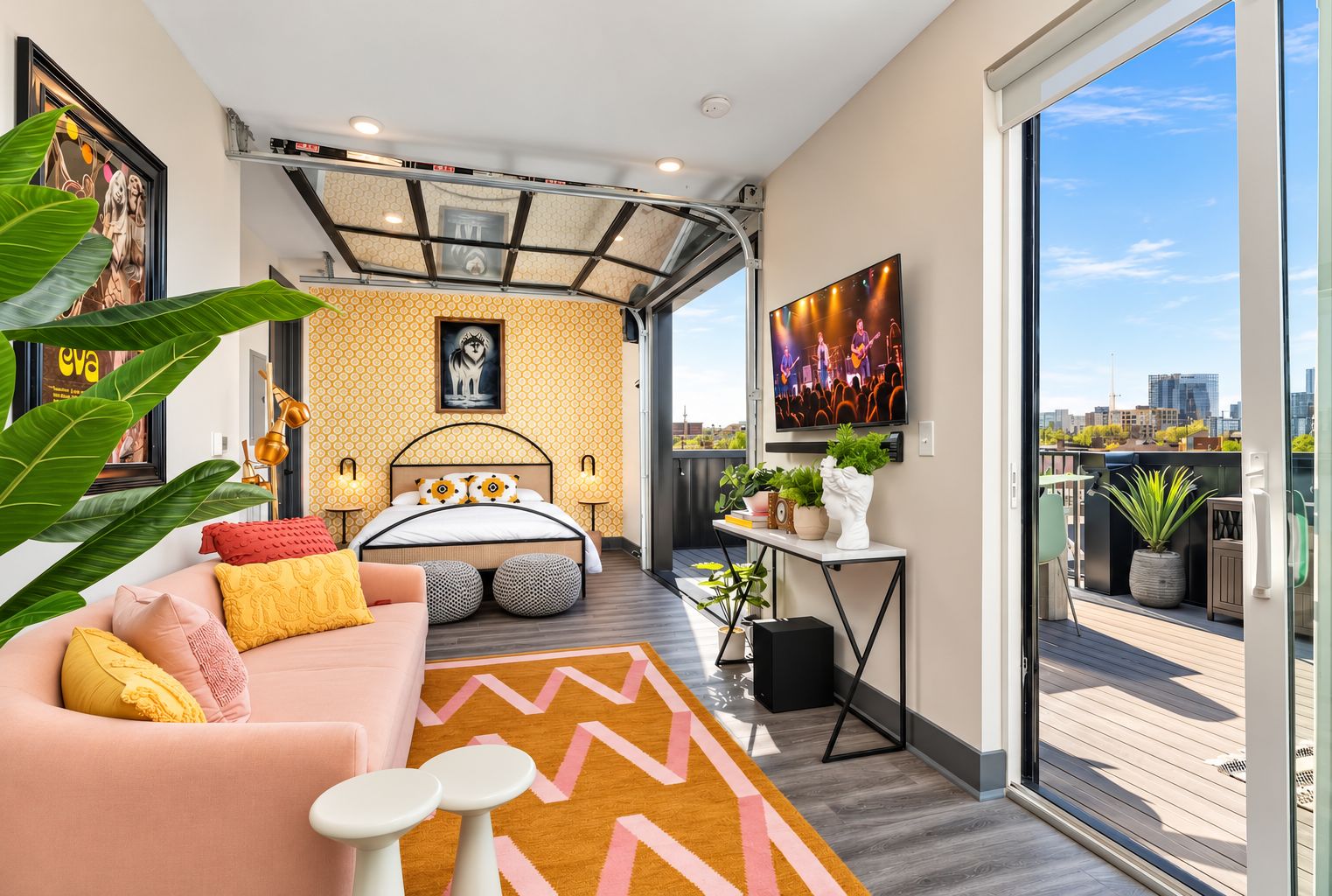 The open-plan bedroom and living room blend together; step through the glass door to one of two private decks overlooking downtown