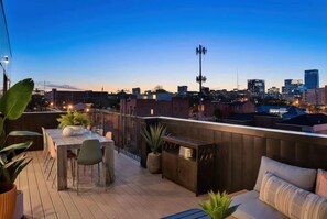 Outdoor dining - Summer rooftop deck, skyline views, glass garage door near Broadway (Nashville)