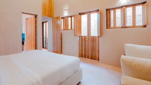 A bedroom with a bed, wooden wardrobe, and a window. - COLÓN · Luxury house with pool and terrace for 6 (Oaxaca)