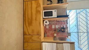 A compact kitchen with a microwave, coffee maker, and a small refrigerator. - GARCIA 5 · Tiny Room in the heart of Oaxaca (Oaxaca)
