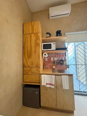 A compact kitchen with a microwave, coffee maker, and a small refrigerator. - GARCIA 5 · Tiny Room in the heart of Oaxaca (Oaxaca)