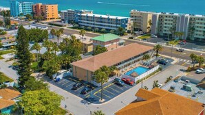 A coastal hotel with a swimming pool, parking, and a view of the ocean. - Tranquil 1-bedroom condo with AC in Madeira Beach completely updated . (Madeira Beach)