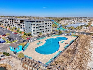 A hotel with a large swimming pool, multiple balconies, and a view of the surrounding area. - Unobstructed Ocean View Escape, Pools + Beach Access (Myrtle Beach)
