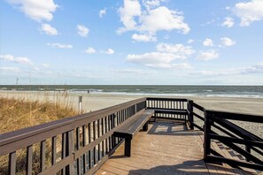 A wooden boardwalk leading to a beach with a clear sky and ocean view. - Unobstructed Ocean View Escape, Pools + Beach Access (Myrtle Beach)