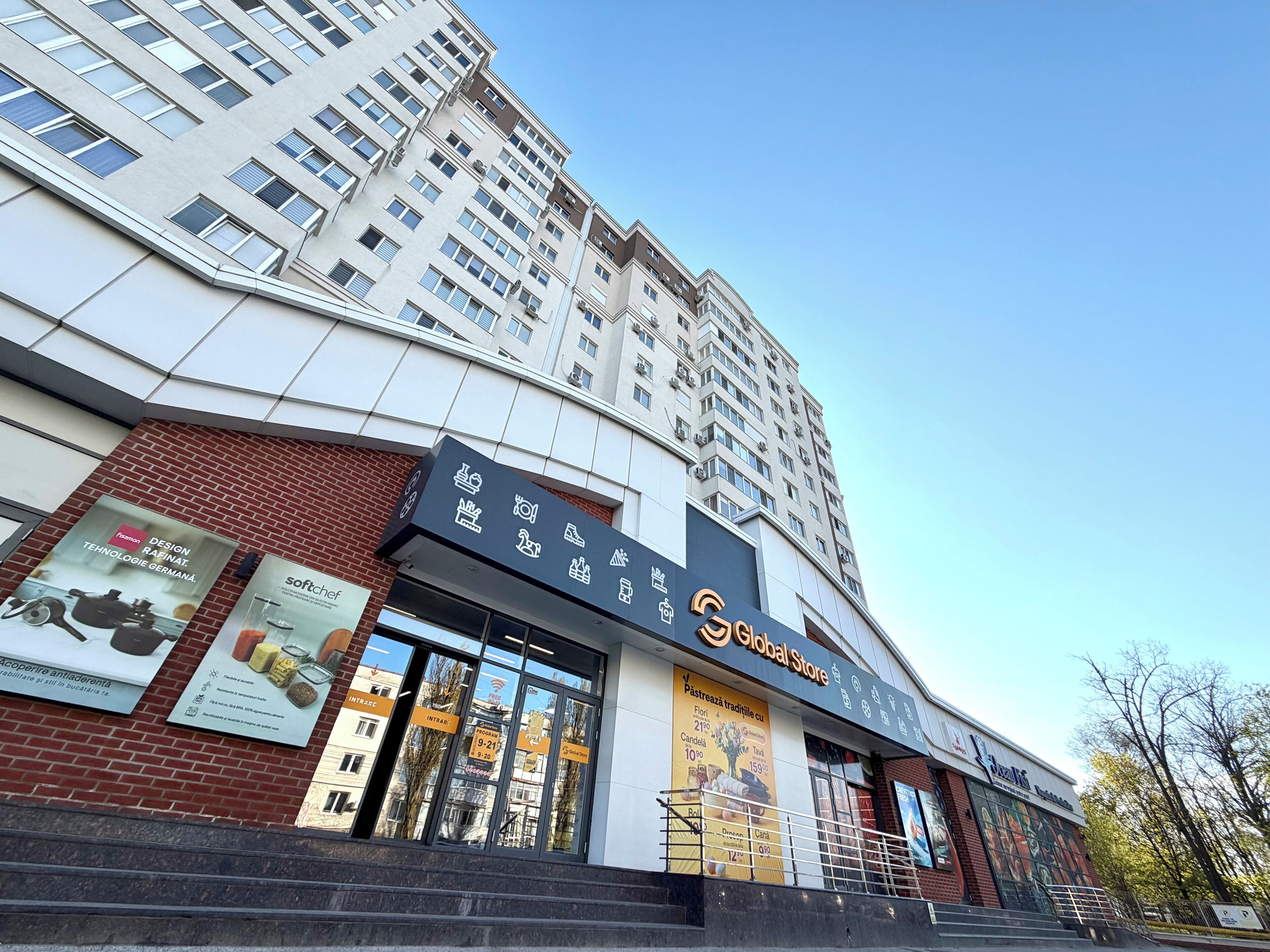 A multi-story building with a prominent 'Global Store' sign, large glass windows, and a brick facade.