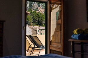 An open door leading to a balcony with a view of buildings and a mountain. - House "Ca'n Gori" - Valldemossa (Valldemossa)