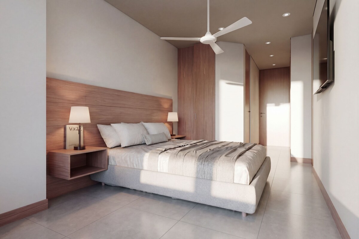 A modern bedroom with a bed, nightstands, a ceiling fan, and a TV.