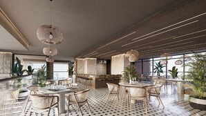 A modern dining area with round tables, wicker chairs, and hanging wicker light fixtures. - Nuruma Suites by Avia Suites (Santa Marta)