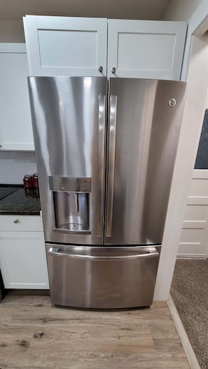 A stainless steel refrigerator with a water dispenser, built-in ice maker, and a freezer compartment.