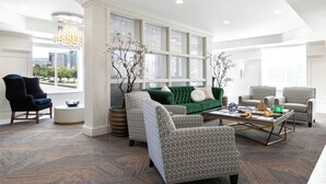 A spacious living room with a green sofa, patterned armchairs, and a coffee table. - Upscale Condo at the Center of It All (Salt Lake City)