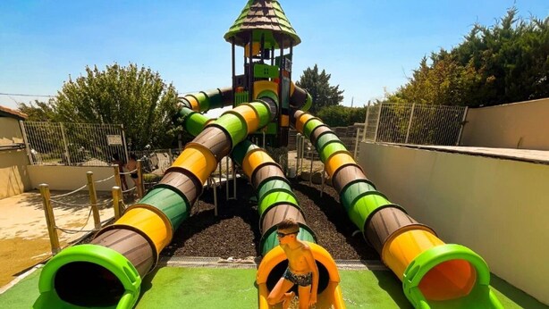 A playground with multiple slides and a climbing structure. - ZEcamping 3 étoiles piscine chauffée tente 18m2 (Lussas)