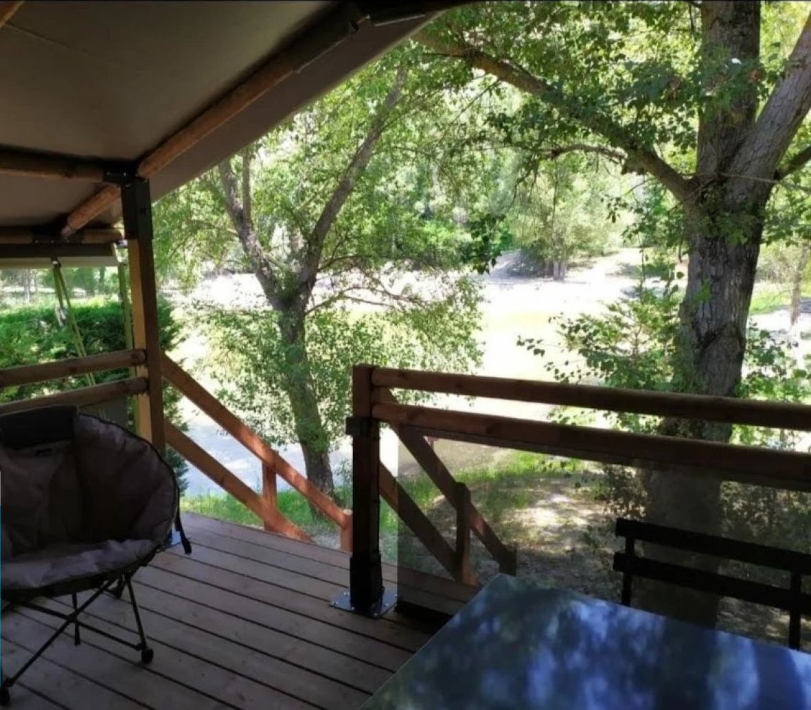 A wooden deck with a view of a wooded area.