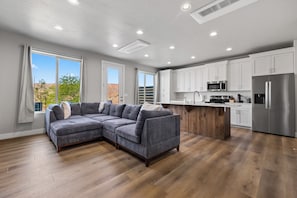 A modern kitchen with white cabinets, stainless steel appliances, and a wooden island. - New Luxury Townhome Near Golf, Trails & Casinos Sleeps 8 in charming Mesquite (Mesquite)