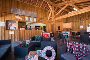 Ein rustikales Holzinterieur mit Barbereich, Sitzgelegenheiten und einer Speisekarte.