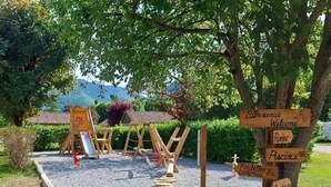 A wooden signpost with directions to various amenities including a pool, restaurant, and a welcome area.