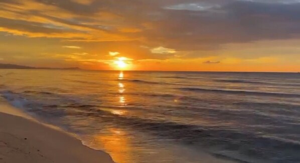 A sunset over a beach with waves reflecting the sky. - Oceanfront House, (Ewa Beach)