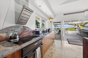 A modern kitchen with a marble countertop, a kettle, and a toaster. - 🌴Hale Honu | AC | Ocean Views | Renovated Master | A Diver's Paradise Awaits🌴 (Kailua Kona)