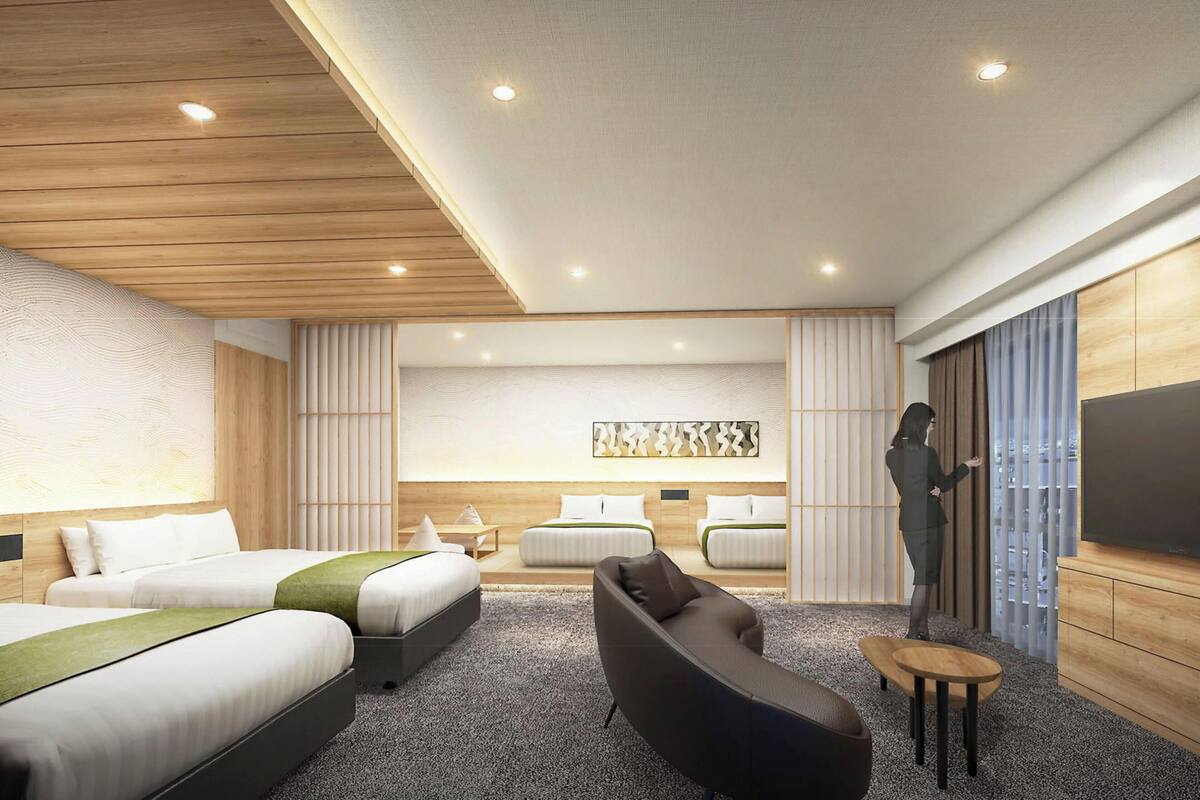 A modern hotel room with three beds, a sofa, a TV, and a large window with curtains.