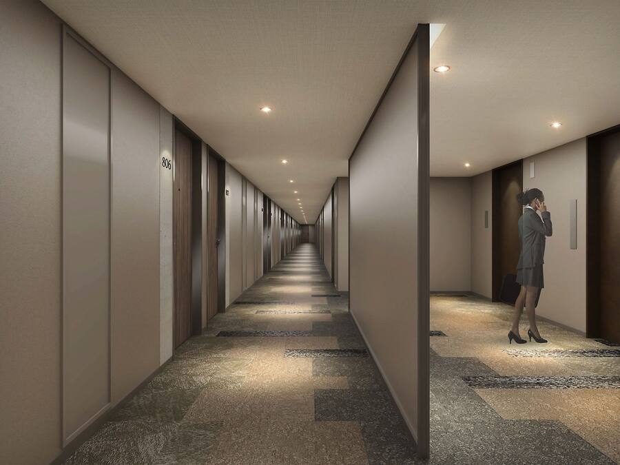 A hotel hallway with a carpeted floor, doors numbered 806 and 807, and recessed lighting.