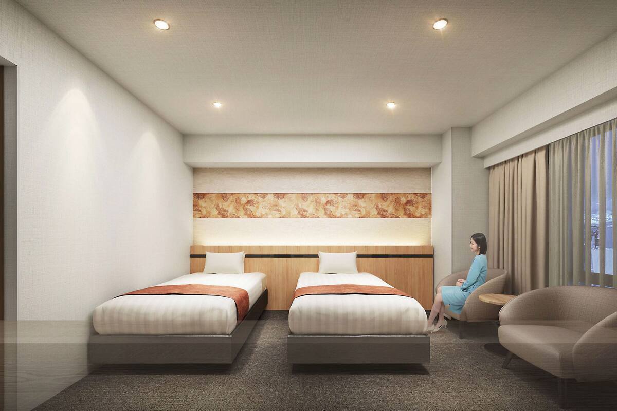 A modern hotel room with two beds, a sofa, a large window with curtains, and a decorative wall panel.