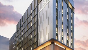 A modern hotel building with a prominent logo, multiple floors, and a flat facade. - Daiwa Roynet Hotel Matsue-ekimae (Matsue)