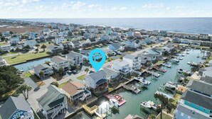 A coastal residential area with houses, a marina, and a body of water. - "Dibbs on Holden" 3 Bedroom, 3 Bathroom, Canal Home (Holden Beach)