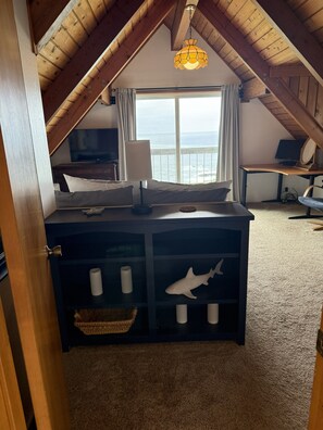 A bedroom with a bed, a desk, a computer, a lamp, a window with a view, and a ceiling fan. - NEW LISTING! Oceanfront Coastal Home-SPECTACULAR VIEWS with Hot Tub & Large Deck (Gualala)
