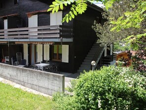 A modern building with a balcony, outdoor seating, and a staircase. - Ski-in/ Ski-out Nordostwand 4-Bett-Ferienwohnung by Interhome (Grindelwald)