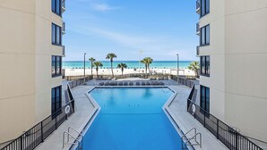 A swimming pool with a view of the beach and ocean. - Sunbird 612 East - Free Beach Chairs! (Panama City)