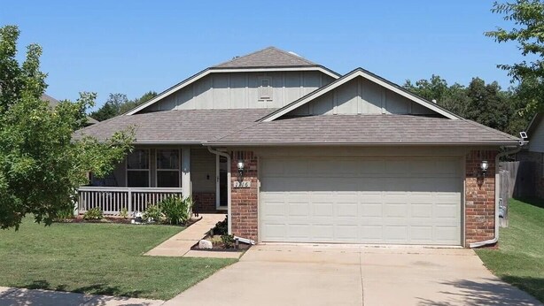 A single-story house with a garage, a front porch, and a well-maintained lawn. - Peaceful 3-bedroom house in charming Stillwater for your getaway (Stillwater)