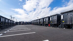 A train station platform with multiple train carriages and overhead electrical lines. - HOTEL R9 The Yard Minamiarupusu (Minami-Alps)