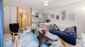 Un ambiente compatto con angolo ristoro, angolo cottura e zona salotto.