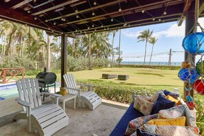 A covered outdoor area with a pool, two Adirondack chairs, a sofa with cushions, and a grill. - 3BR Beach Essence Terrenas Pool Maid Beachfront (Las Terrenas)