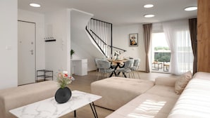 A modern living room with a sofa, a dining table, and a staircase. - Mediterranee Oliva by Interhome (Poreč/Funtana)