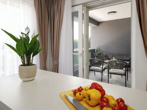 A kitchen with a cutting board, a knife, and a potted plant. - Mediterranee Oliva by Interhome (Poreč/Funtana)